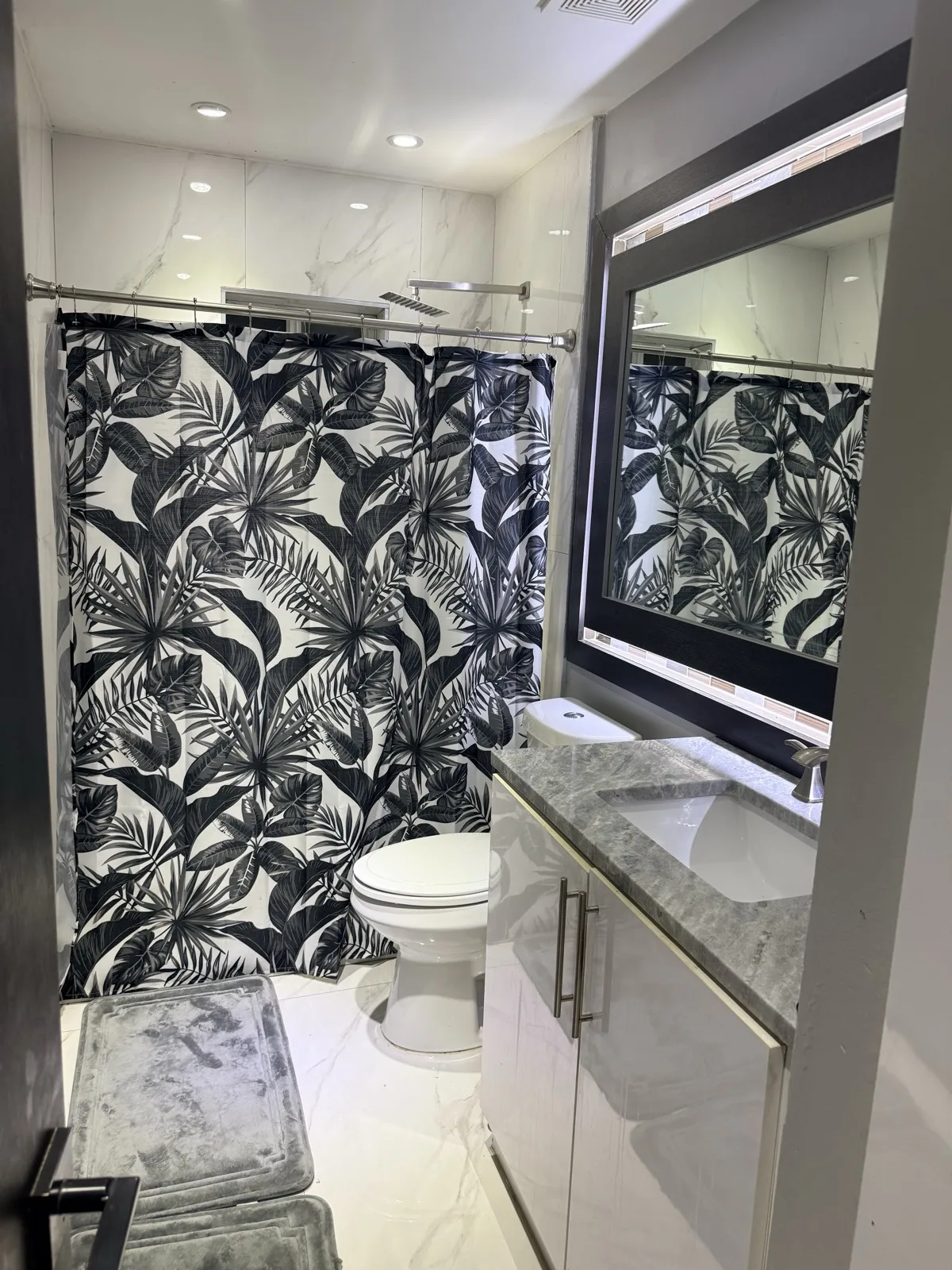 Bodied in MIA suite bathroom — clean, warm, guest-ready