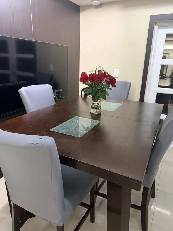 Bodied in MIA dining area set with fresh roses